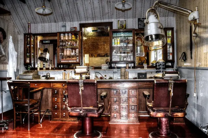 A classic barber shop interior with leather chairs and wooden cabinets